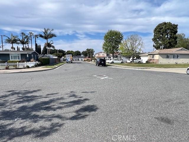 view of road featuring a residential view, sidewalks, and curbs