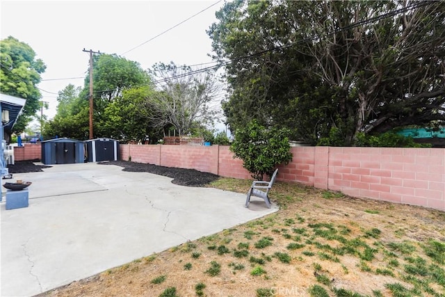 exterior space with a storage shed, an outdoor structure, and a fenced backyard