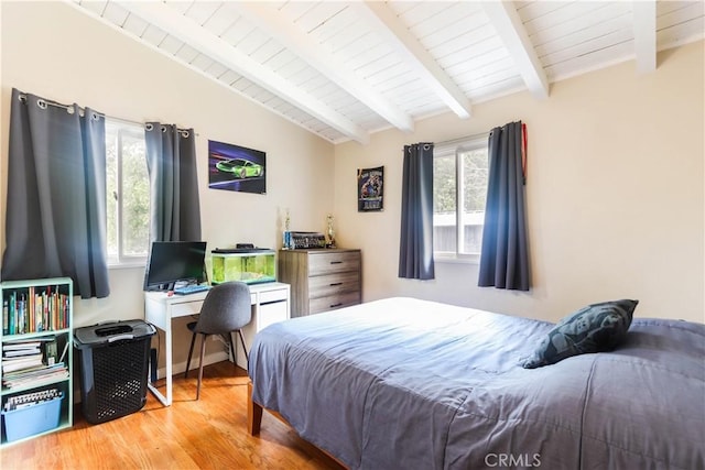bedroom featuring lofted ceiling with beams, wooden ceiling, and wood finished floors