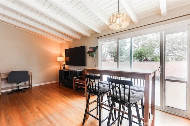 dining area with wooden ceiling, lofted ceiling with beams, an inviting chandelier, light wood finished floors, and baseboards