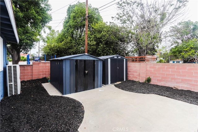 view of shed with fence