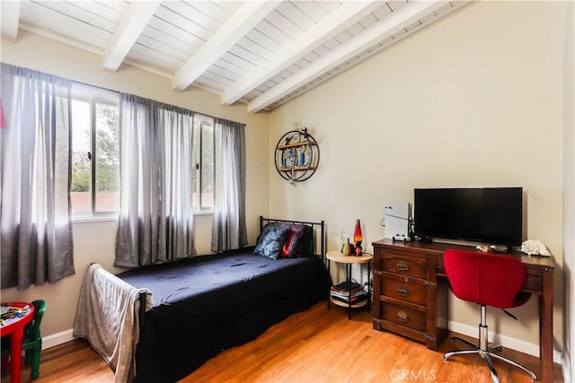 bedroom featuring vaulted ceiling with beams, light wood-style flooring, and wood ceiling