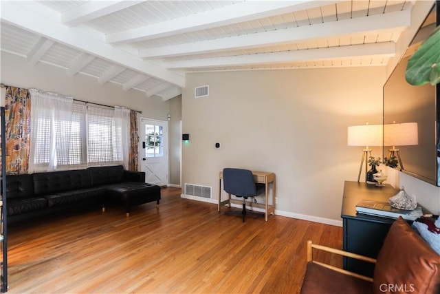 living room featuring visible vents, vaulted ceiling with beams, and light wood-type flooring