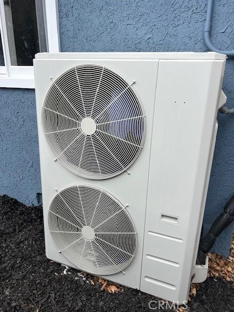 details with stucco siding and ac unit