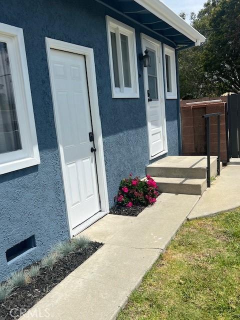 property entrance with stucco siding