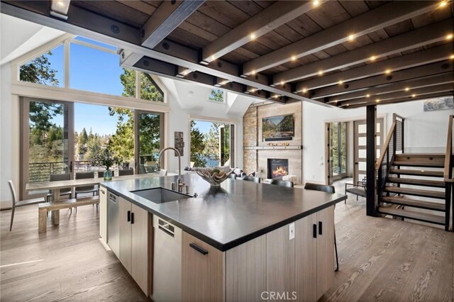 496 N State Highway 173, Lake Arrowhead, CA 92352 - kitchen with dark countertops, a spacious island, light wood-type flooring, a large fireplace, and wood ceiling