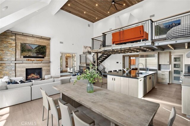 496 N State Highway 173, Lake Arrowhead, CA 92352 - dining space featuring high vaulted ceiling, light wood finished floors, a fireplace, beam ceiling, and recessed lighting