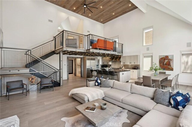 496 N State Highway 173, Lake Arrowhead, CA 92352 - living room with high vaulted ceiling, light wood finished floors, a ceiling fan, and beamed ceiling