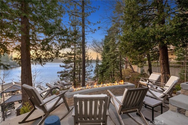 496 N State Highway 173, Lake Arrowhead, CA 92352 - view of patio with an outdoor fire pit and a water view