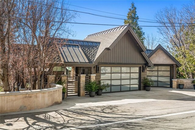 496 N State Highway 173, Lake Arrowhead, CA 92352 - view of front facade with a shingled roof, concrete driveway, stone siding, a gate, and a garage