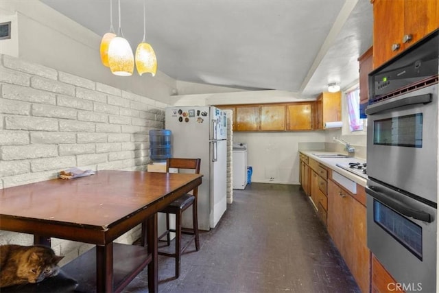1768 Wright St, Pomona, CA 91766 - kitchen with white appliances, brown cabinets, light countertops, vaulted ceiling, and washer / dryer