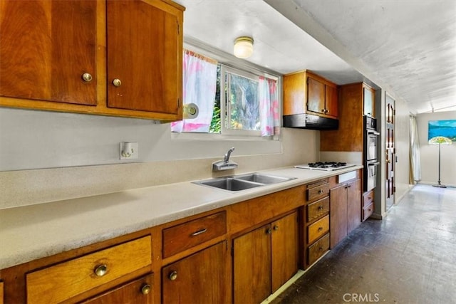 1768 Wright St, Pomona, CA 91766 - kitchen with a sink, light countertops, brown cabinets, dark floors, and double oven
