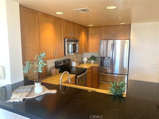 kitchen with recessed lighting, backsplash, visible vents, and stainless steel appliances