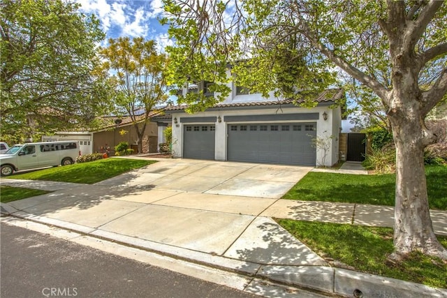 11834 Greenbluff Way, Yucaipa, CA 92399 - view of front of property with driveway, stucco siding, a tiled roof, and a garage