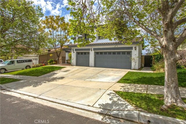 11834 Greenbluff Way, Yucaipa, CA 92399 - view of front of house with concrete driveway, stucco siding, and a tile roof