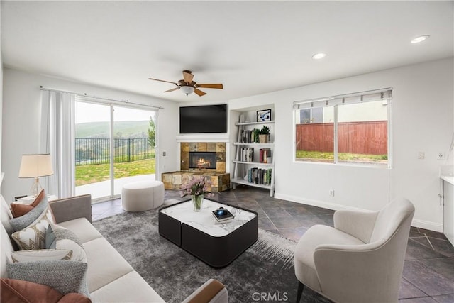 11834 Greenbluff Way, Yucaipa, CA 92399 - living area featuring a ceiling fan, a stone fireplace, built in features, and recessed lighting