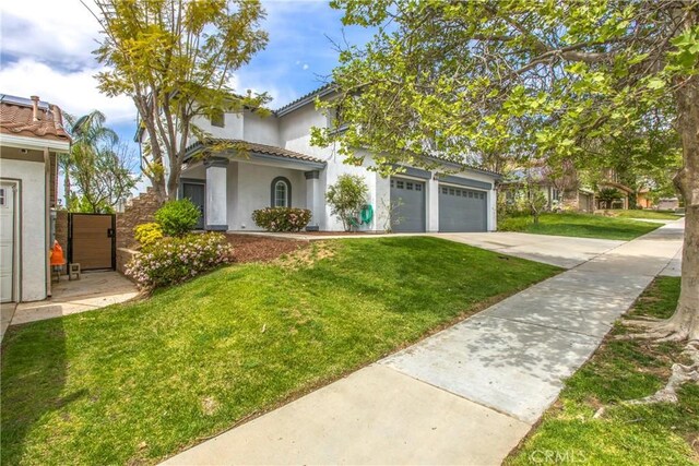 11834 Greenbluff Way, Yucaipa, CA 92399 - view of front of property with concrete driveway, stucco siding, a front lawn, a garage, and a tile roof