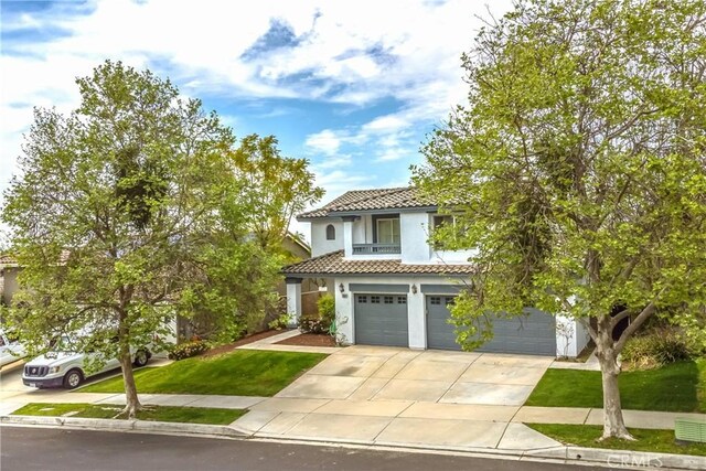 11834 Greenbluff Way, Yucaipa, CA 92399 - mediterranean / spanish home featuring a tiled roof, a garage, concrete driveway, stucco siding, and a front yard