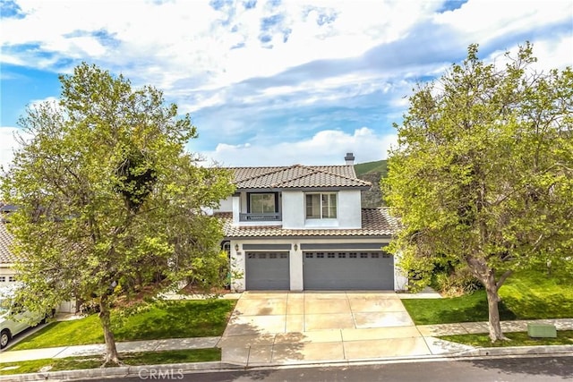 11834 Greenbluff Way, Yucaipa, CA 92399 - view of front of house with a tile roof, concrete driveway, a garage, stucco siding, and a chimney