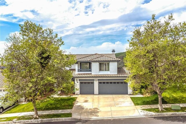 11834 Greenbluff Way, Yucaipa, CA 92399 - view of front of home featuring a tile roof, an attached garage, concrete driveway, stucco siding, and a chimney