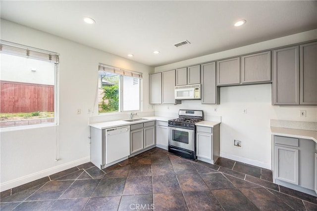 11834 Greenbluff Way, Yucaipa, CA 92399 - kitchen with white appliances, gray cabinetry, baseboards, light countertops, and recessed lighting