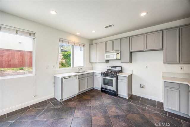 11834 Greenbluff Way, Yucaipa, CA 92399 - kitchen with white appliances, gray cabinets, light countertops, and recessed lighting