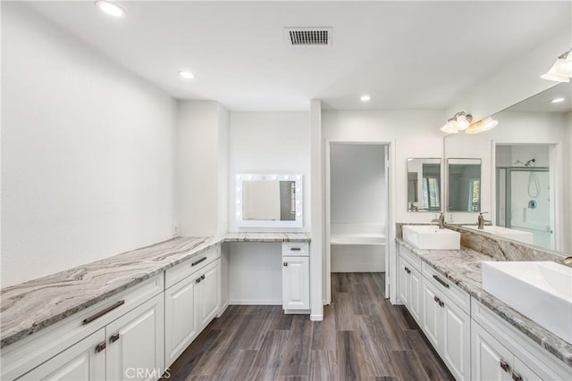 11834 Greenbluff Way, Yucaipa, CA 92399 - bathroom with double vanity, a stall shower, wood finished floors, recessed lighting, and a tub to relax in