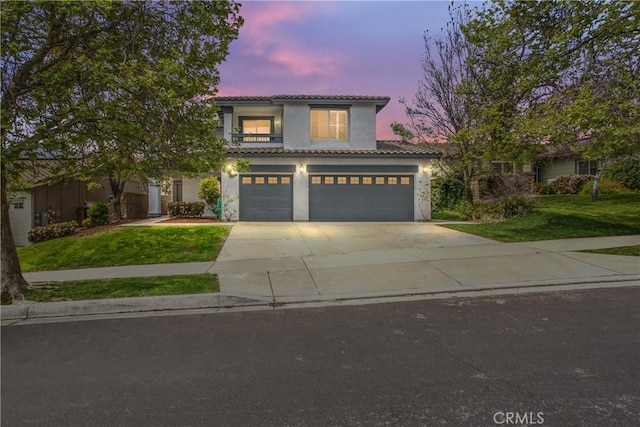 11834 Greenbluff Way, Yucaipa, CA 92399 - mediterranean / spanish home featuring driveway, a tiled roof, a front lawn, stucco siding, and an attached garage