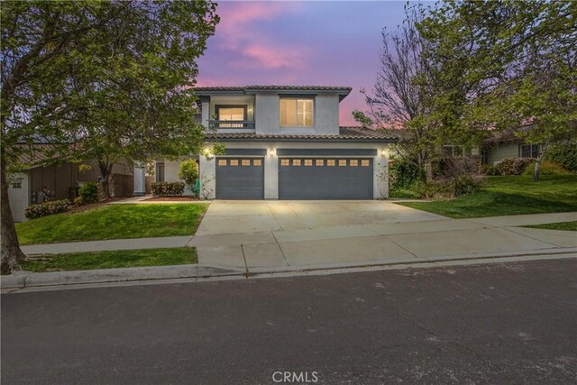 11834 Greenbluff Way, Yucaipa, CA 92399 - mediterranean / spanish-style house featuring concrete driveway, a tile roof, a lawn, stucco siding, and a garage