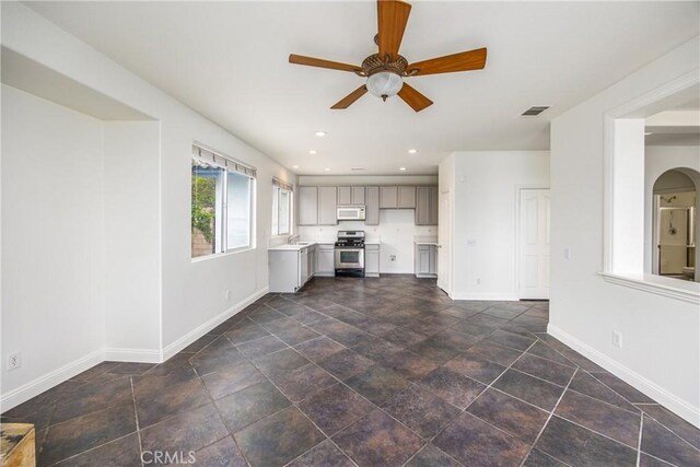 11834 Greenbluff Way, Yucaipa, CA 92399 - unfurnished living room featuring baseboards, a ceiling fan, recessed lighting, a sink, and dark stone finish floors