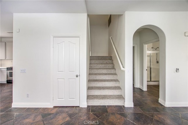 11834 Greenbluff Way, Yucaipa, CA 92399 - stairs with baseboards, stone tile flooring, and arched walkways