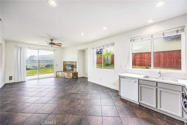11834 Greenbluff Way, Yucaipa, CA 92399 - kitchen featuring dishwasher, a sink, a fireplace, a ceiling fan, and light countertops