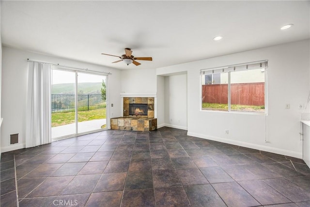 11834 Greenbluff Way, Yucaipa, CA 92399 - unfurnished living room with ceiling fan, baseboards, a stone fireplace, and recessed lighting