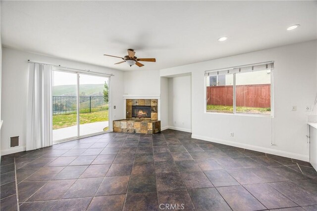 11834 Greenbluff Way, Yucaipa, CA 92399 - unfurnished living room with a ceiling fan, a stone fireplace, and recessed lighting