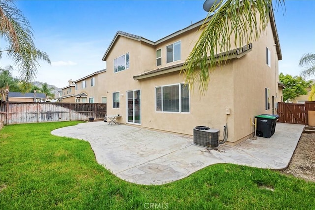 back of house with cooling unit, a yard, a fenced backyard, stucco siding, and a patio