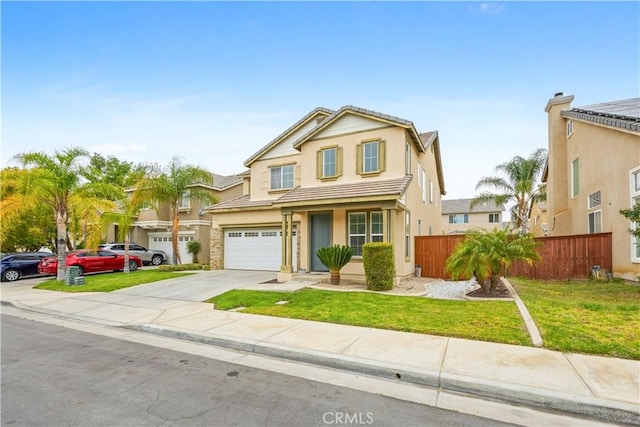 traditional home featuring concrete driveway, stucco siding, a front yard, a garage, and fence
