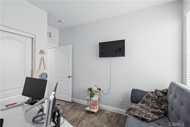 office with visible vents, baseboards, and wood finished floors