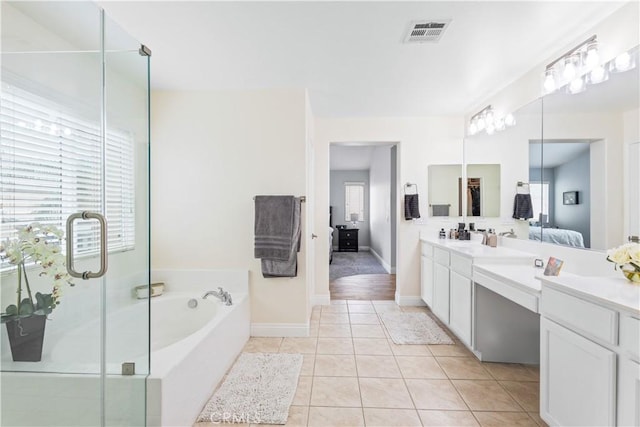 bathroom featuring a garden tub, ensuite bathroom, vanity, tile patterned flooring, and visible vents