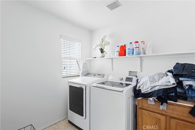 laundry room with visible vents, light tile patterned floors, washer and dryer, and laundry area