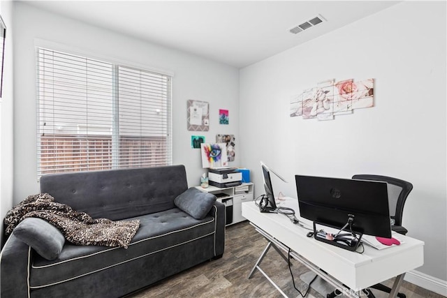 office area with a healthy amount of sunlight, wood finished floors, and visible vents