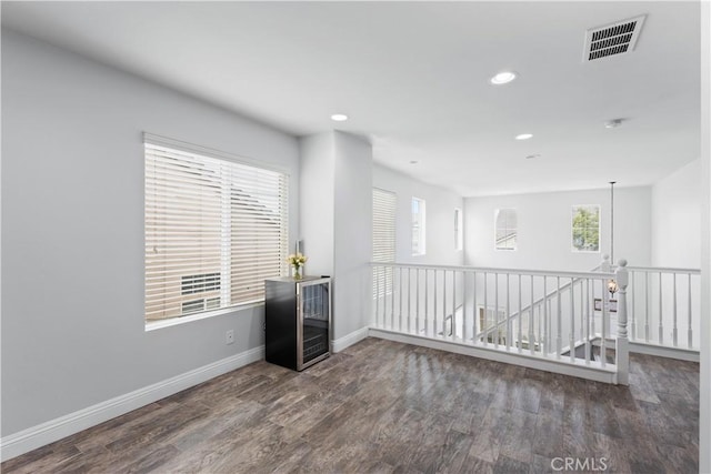 spare room featuring recessed lighting, visible vents, baseboards, and wood finished floors