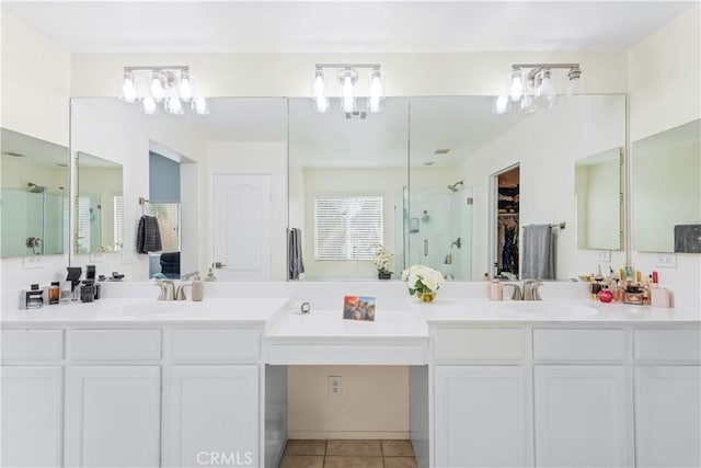 bathroom with tile patterned floors, a stall shower, and vanity