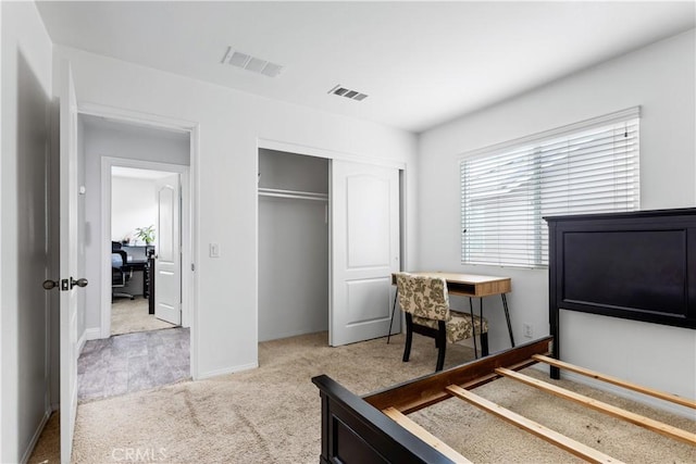 bedroom featuring visible vents, a closet, baseboards, and carpet floors