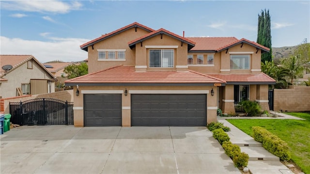 4022 Cocina Ln, Palmdale, CA 93551 - view of front of home with concrete driveway, stucco siding, fence, a tiled roof, and a gate