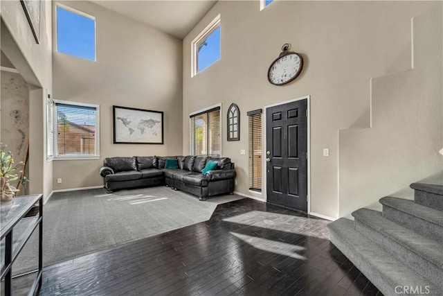 4022 Cocina Ln, Palmdale, CA 93551 - living room with baseboards, stairway, hardwood / wood-style flooring, and a towering ceiling