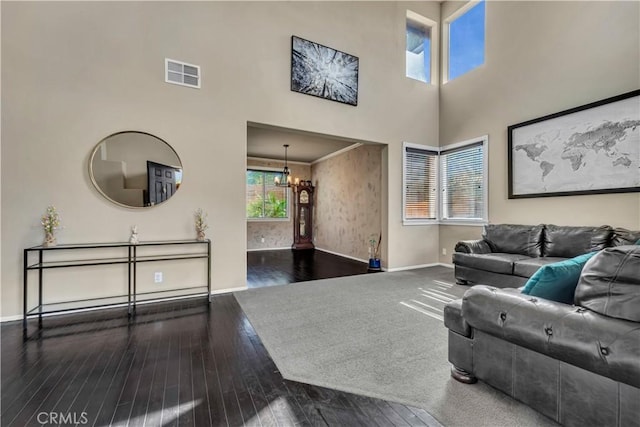 4022 Cocina Ln, Palmdale, CA 93551 - living room featuring baseboards, an inviting chandelier, a high ceiling, visible vents, and hardwood / wood-style flooring