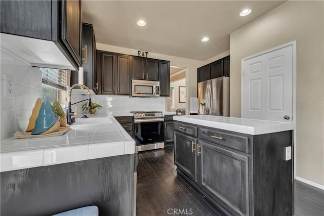 4022 Cocina Ln, Palmdale, CA 93551 - kitchen featuring a sink, backsplash, appliances with stainless steel finishes, and dark wood-type flooring