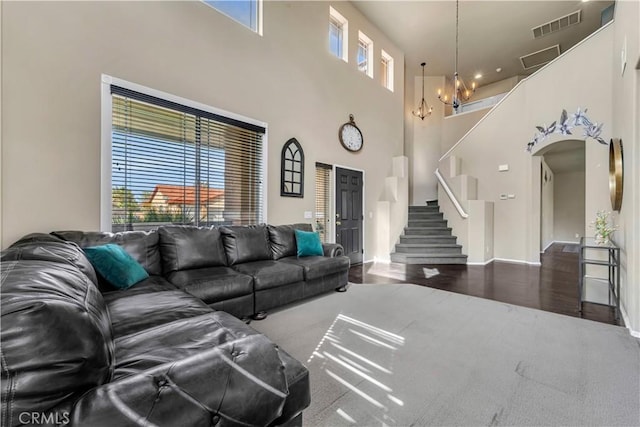 4022 Cocina Ln, Palmdale, CA 93551 - living room with visible vents, a notable chandelier, stairway, a towering ceiling, and wood finished floors