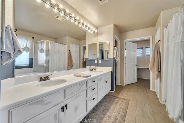 4022 Cocina Ln, Palmdale, CA 93551 - bathroom with a sink, visible vents, double vanity, and a stall shower