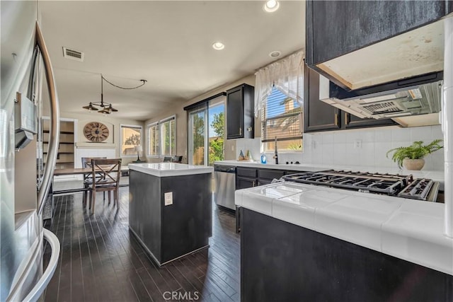 4022 Cocina Ln, Palmdale, CA 93551 - kitchen with tasteful backsplash, visible vents, stainless steel appliances, tile countertops, and a sink